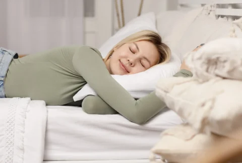 relaxing-young-woman-lying-on-pillow-in-bed-healt-2023-11-27-05-11-00-utc-min